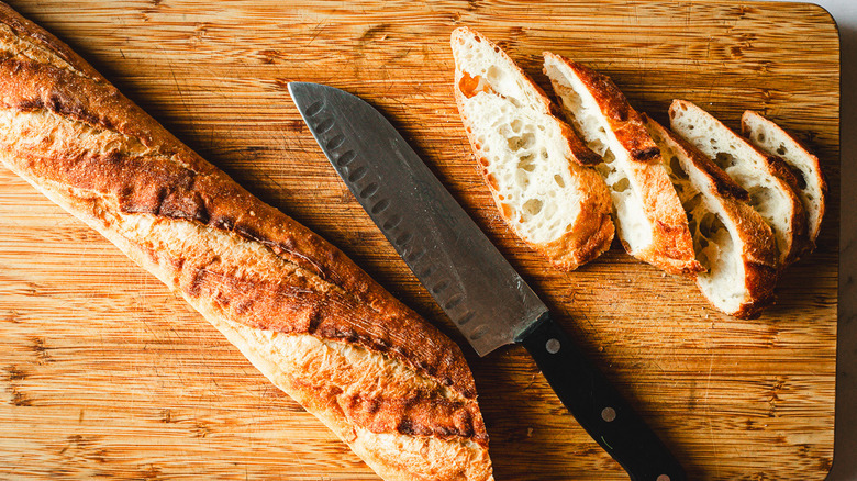 Knife and baguette slices on cutting board