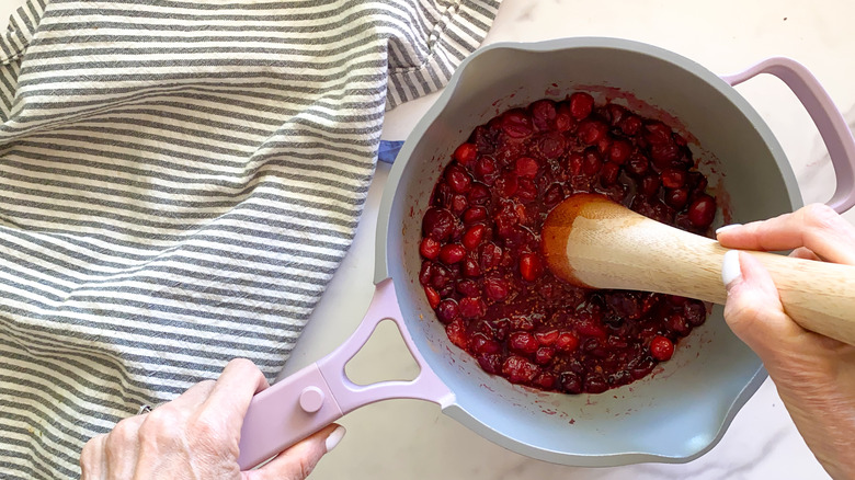 mashing cranberries