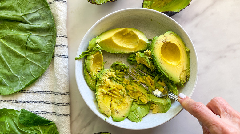 mashed avocado in white bowl