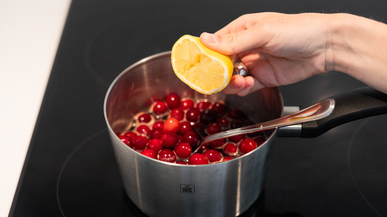 lemon being squeezed into pot