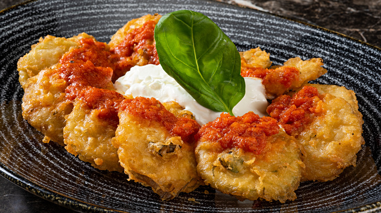 fritters with red and white sauce on serving platter