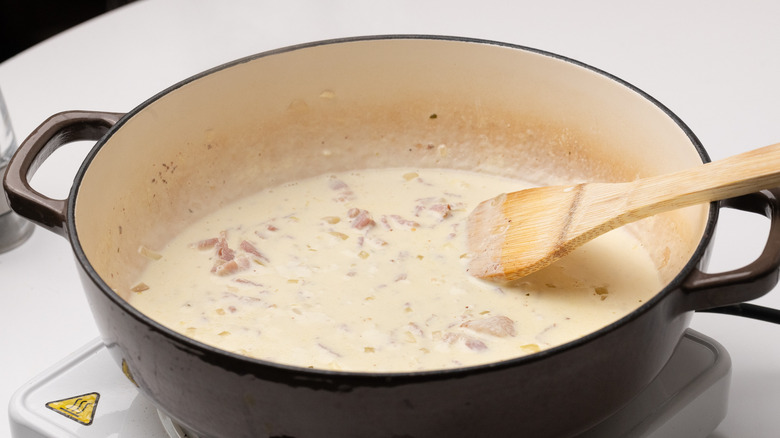 cooking creamy sauce in pan