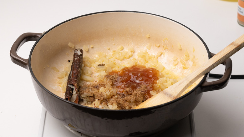 adding spices to a pan