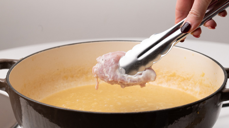 adding chicken to korma sauce