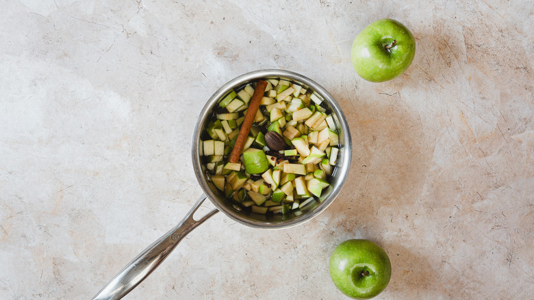 Apples and spices in saucepan