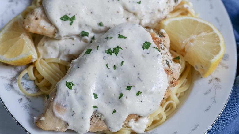 creamy chicken, noodles, and lemon wedge