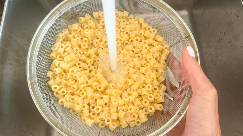 rinsing pasta under faucet