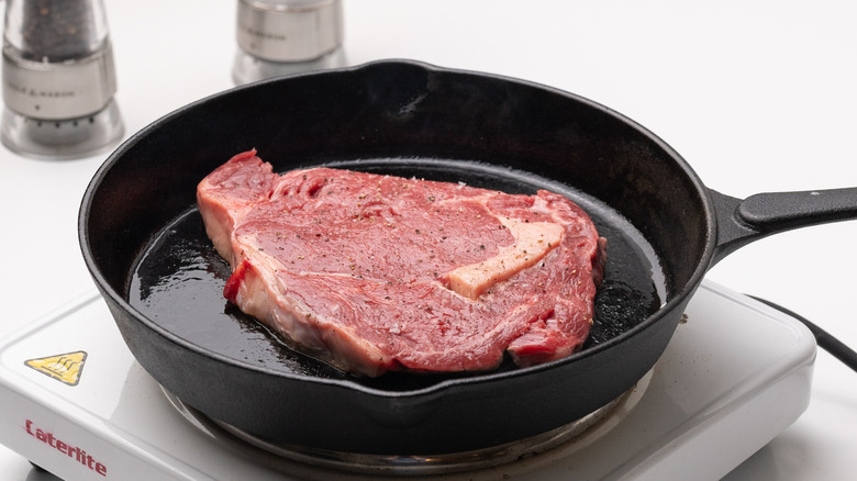 steak searing in cast iron pan
