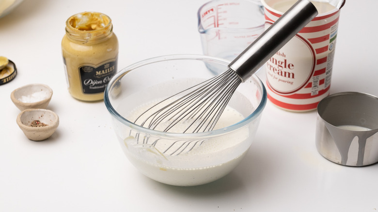 whisking cream in a bowl