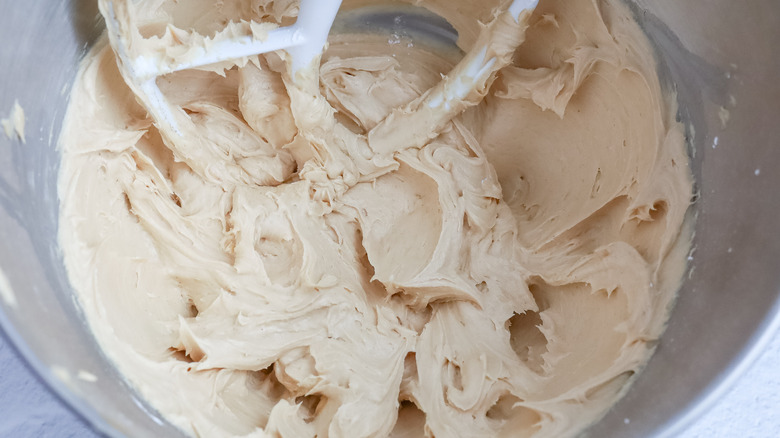 mixing creamy peanut butter frosting