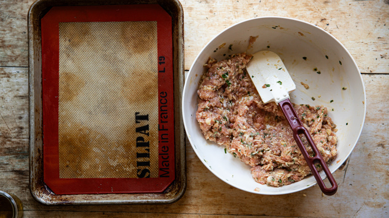 Mixing raw meatball ingredients