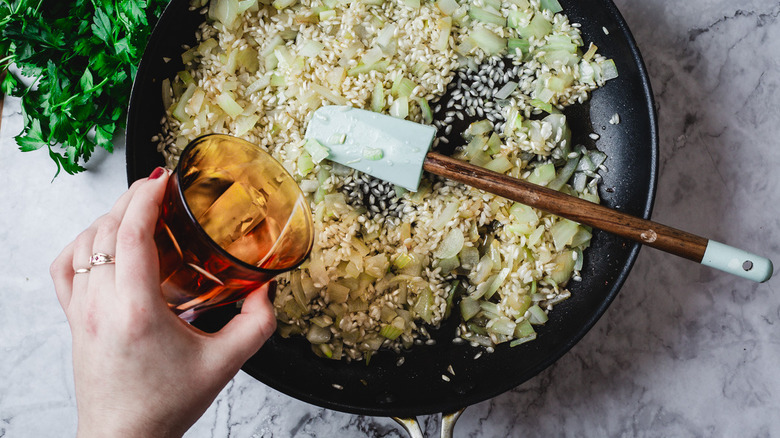 White wine added to pan of risotto