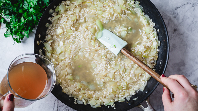 Stock added to pan of risotto