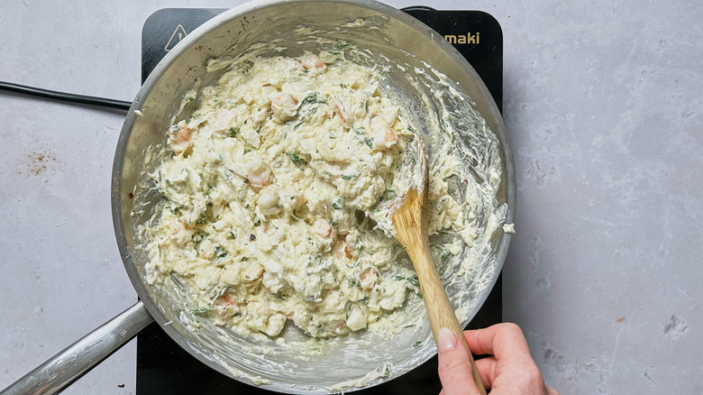 stirring crab mixture in skillet