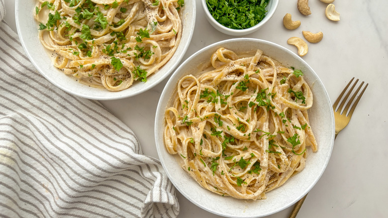 Two bowls of vegan fettuccine Alfredo