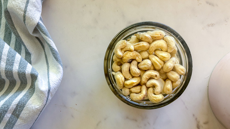 Cashews in glass bowl with water