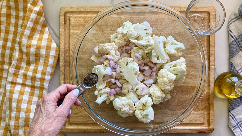 adding pepper to bowl