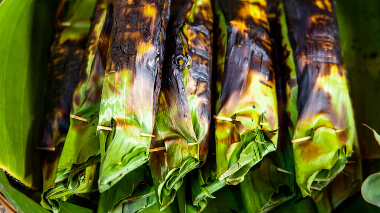 sticky rice wrapped in charred banana leaves