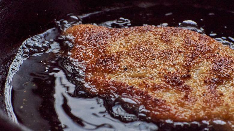 frying chicken in a skillet