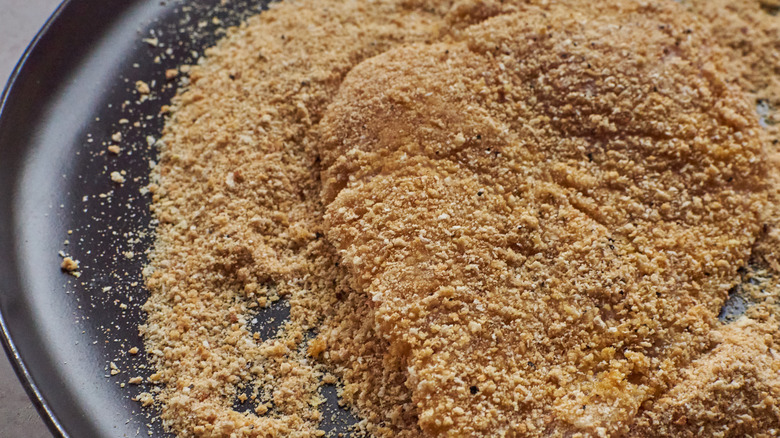 raw chicken cutlet in crumbs