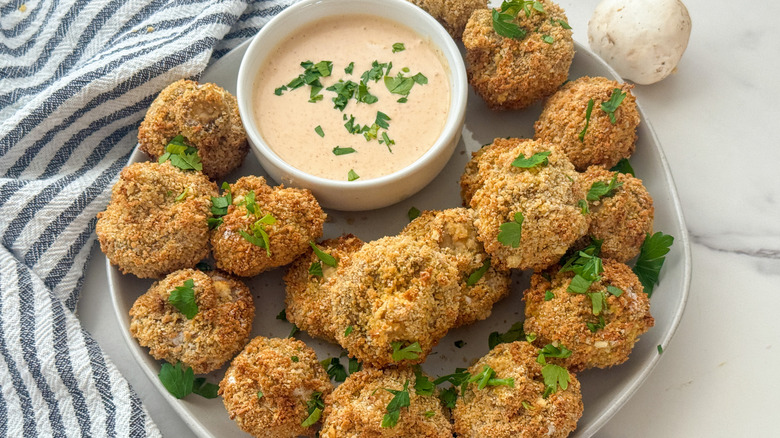 mushrooms on platter with sauce