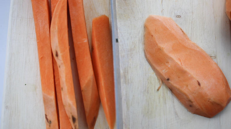 peeled sweet potato on cutting board