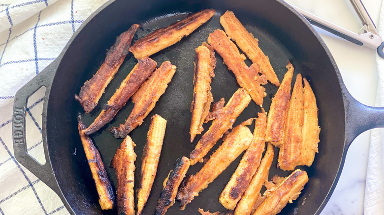 Baby corn frying in a pan