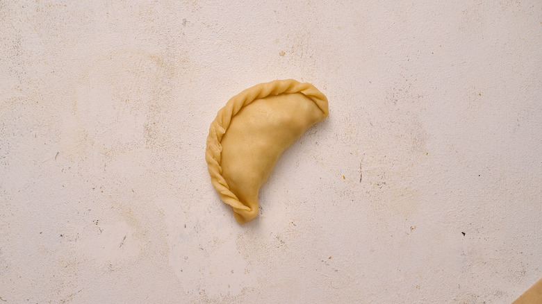 folded empanada on table