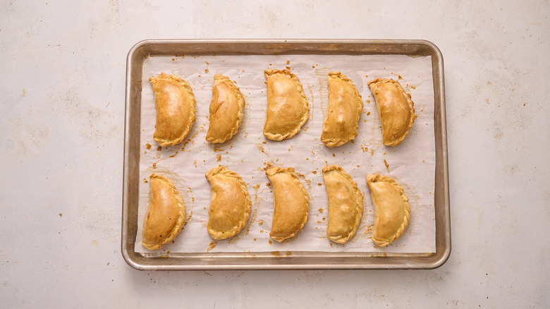 empanadas baked on sheet tray