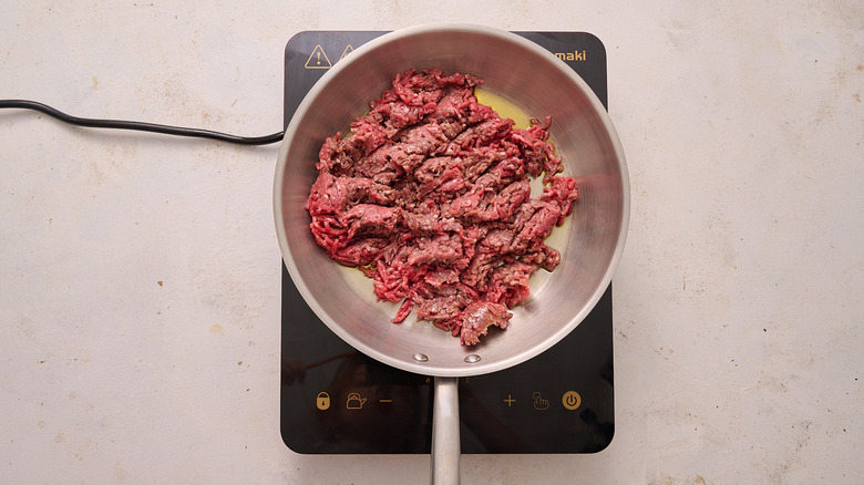 crumble and brown beef in skillet