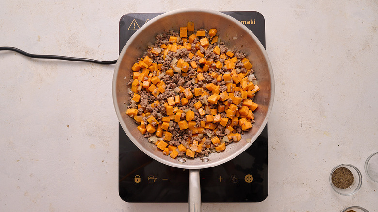 beef and sweet potatoes in skillet