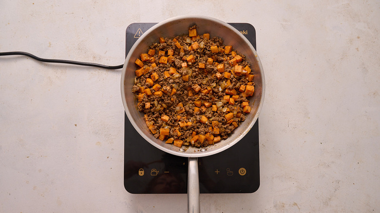 seasoned beef and potato in skillet