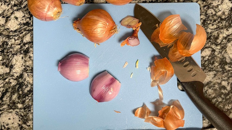 cut and peeled shallots on cutting board