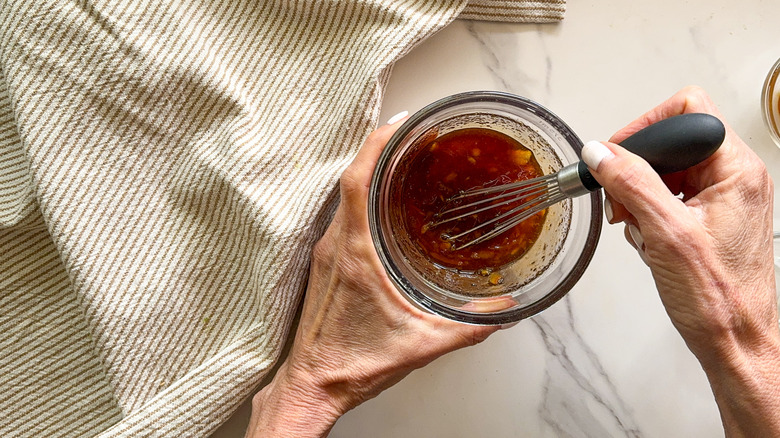 hand holding jar with whisk