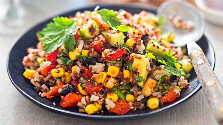 corn salad on a black plate