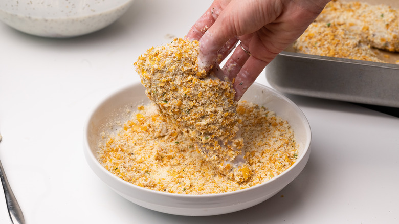 Coating chicken in cornflake mix