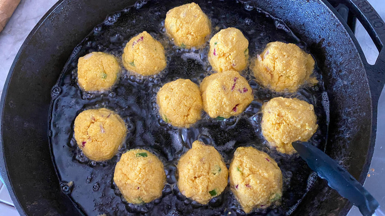 dough balls frying in skillet