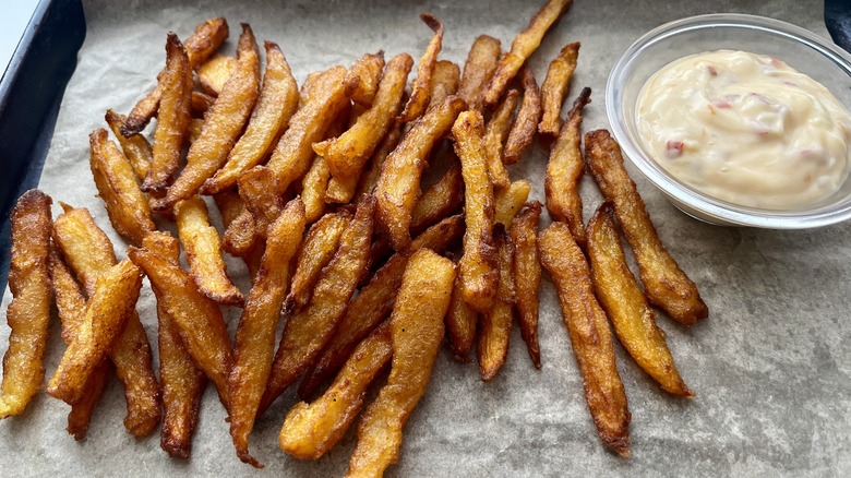 fries with mayonnaise sauce on tray