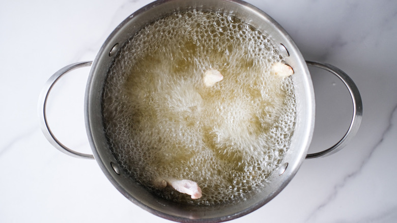 chicken frying in pot