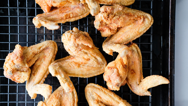 fried chicken resting on rack