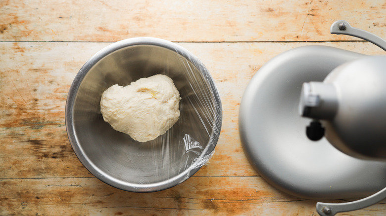 Dough resting in covered bowl