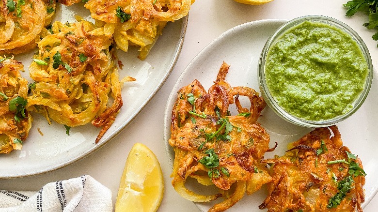 2 bhajis on plate with sauce