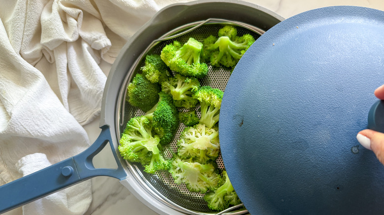 removing lid from pan