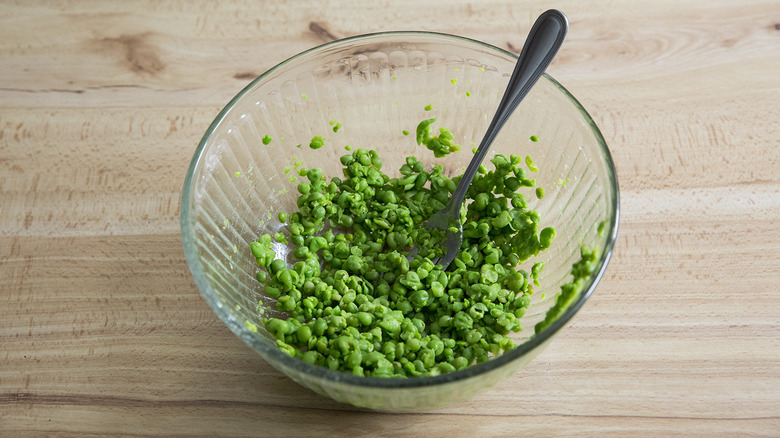 fork mashed peas in bowl