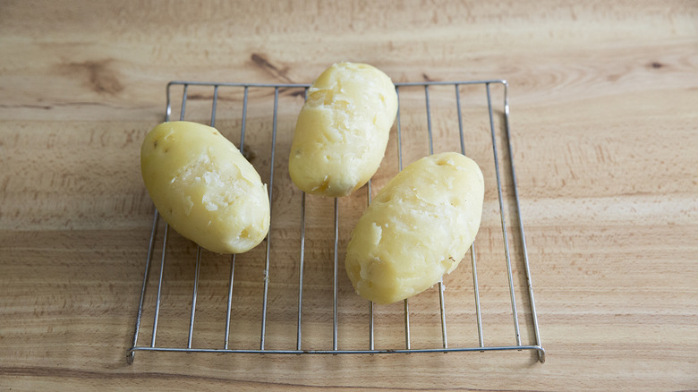 peeled potatoes on wire rack