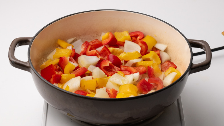 stir-frying peppers and onions