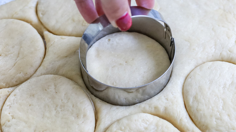 hand cutting dough into circles