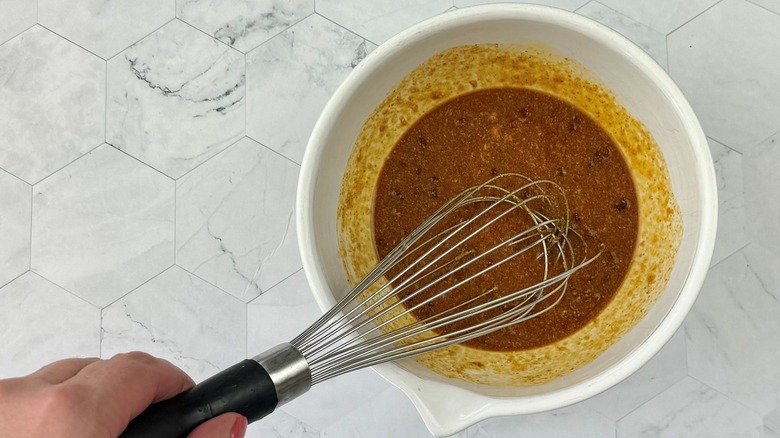 whisking sauce in bowl