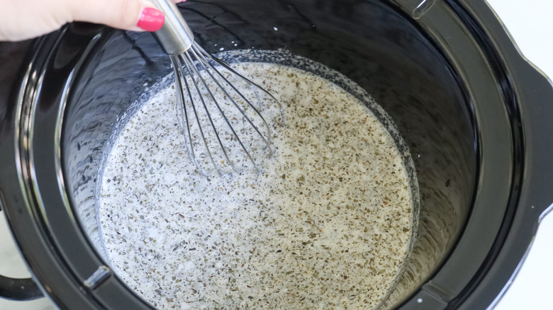 whisking cream and herb sauce