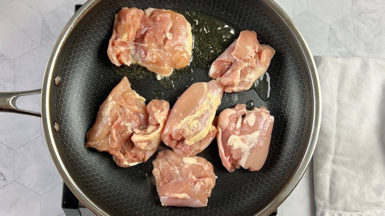 raw chicken thighs in pan